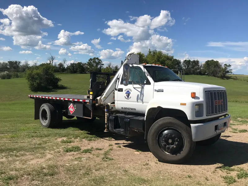 A photo of a an empty Boom Truck with the Rough Riders Logo on the door