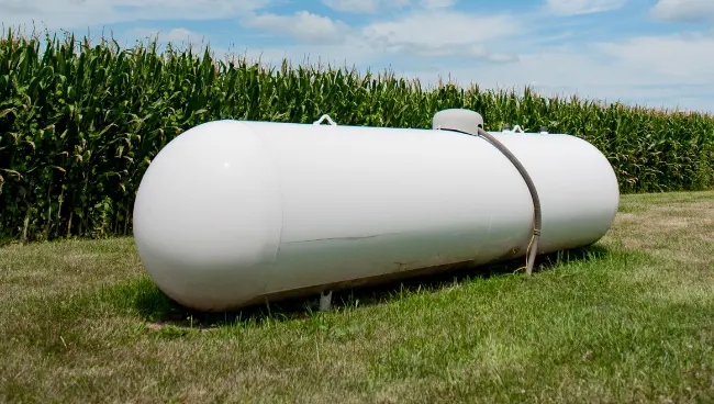 residential-propane-tanks a photo of a large propane tank on a residential property outside a corn field