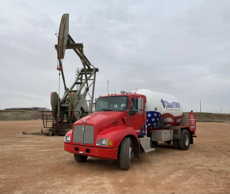 a photo of the Rough Rider truck out in front of a oil rig